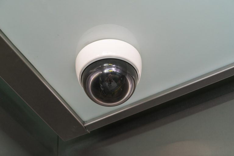 circular cctv installed in a corner of a room