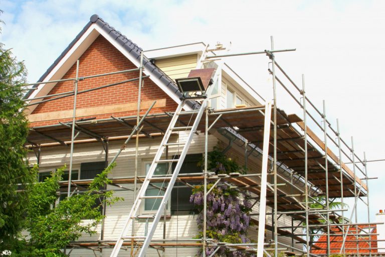 scaffolding setup around a house undergoing a renovation