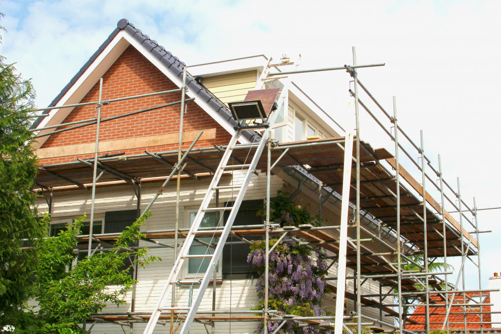 house being remodeled with scaffoldings around it