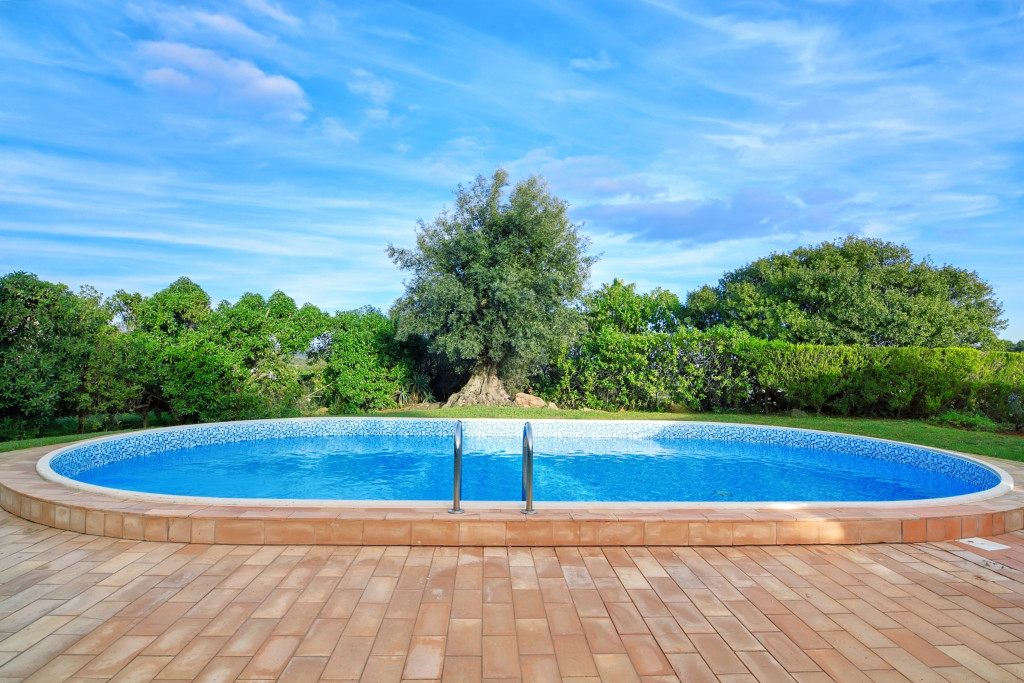 An oblong-shaped swimming pool in a backyard