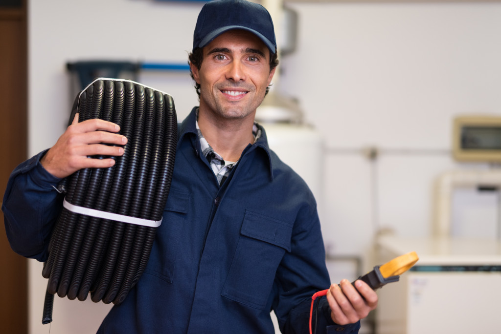 man in workers outfit smiling