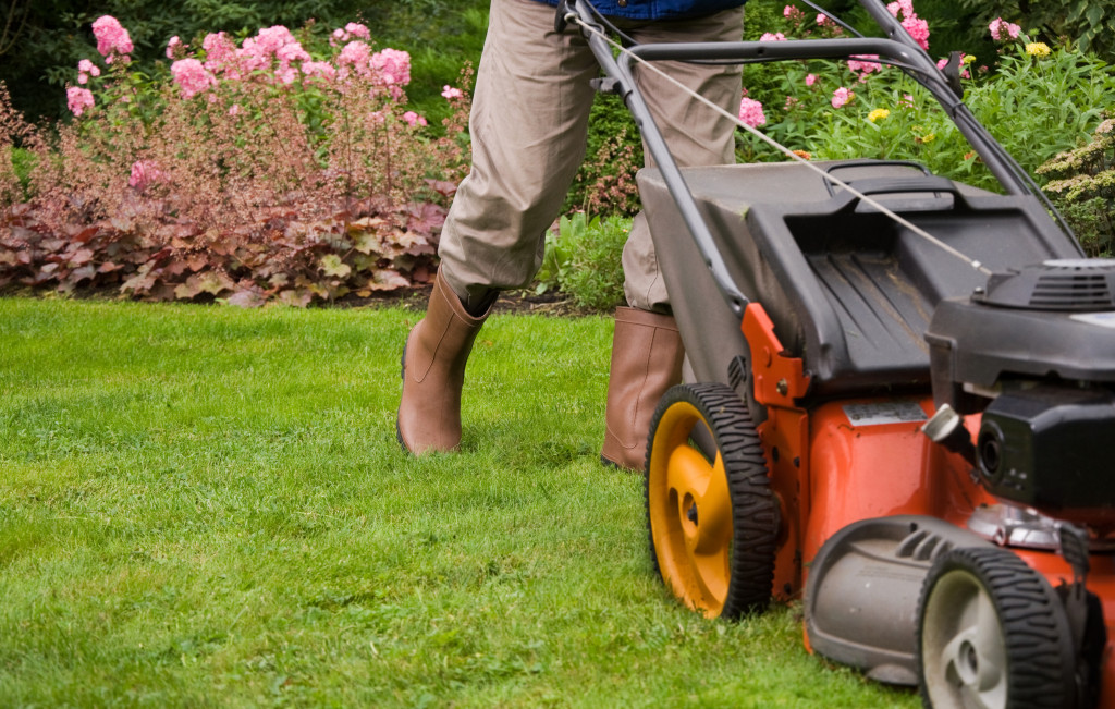 a man doing a lawn mowing