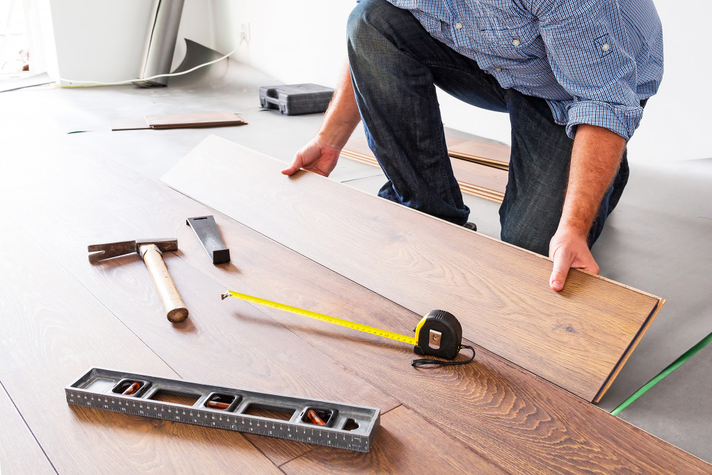 A worker installing a wooden floor