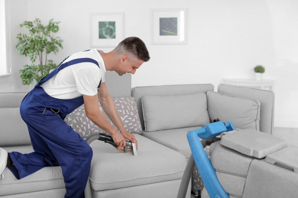 man doing a deep cleaning on the couch