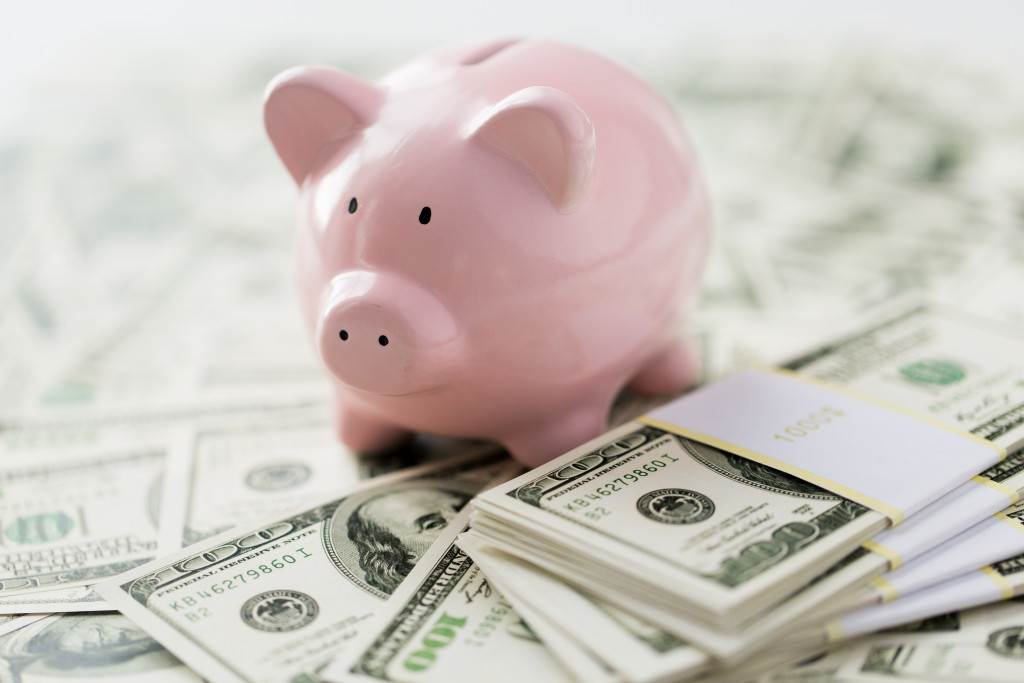 A piggy bank over cash money