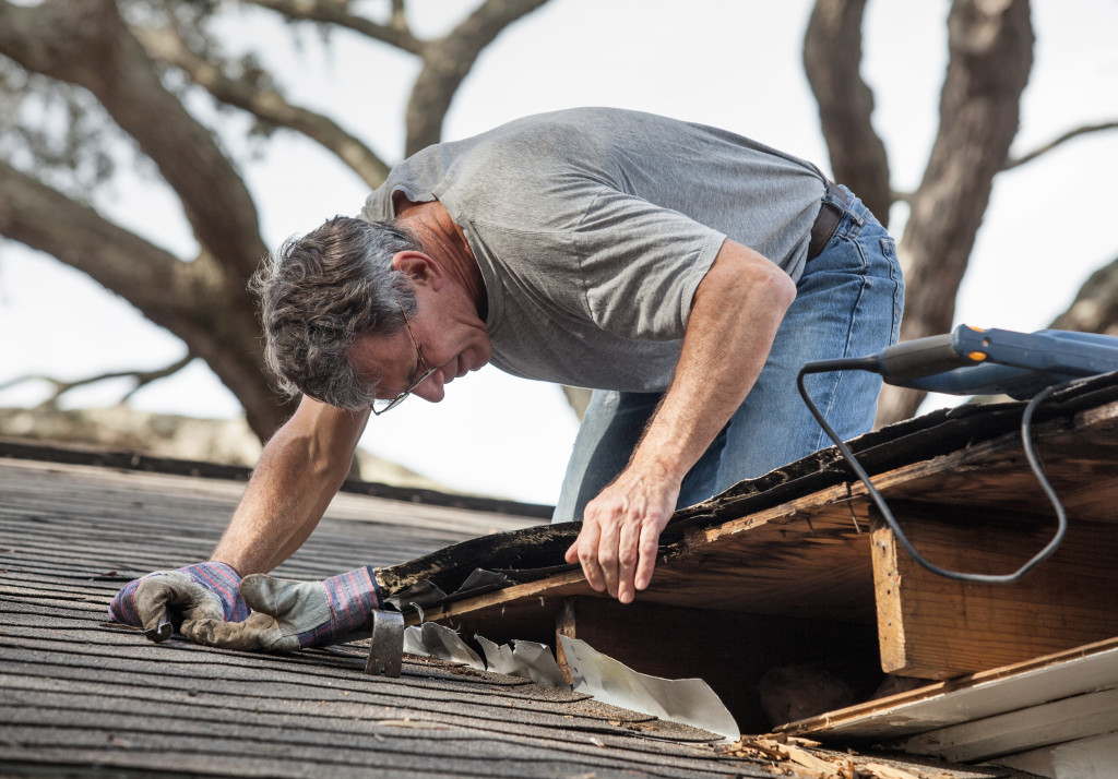 man checking the roof