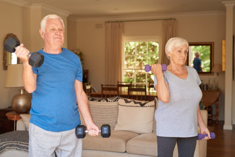 senior couple exercising at home