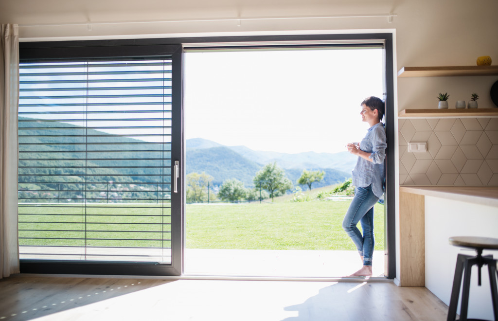 woman standing in the frame of a sliding door in the home