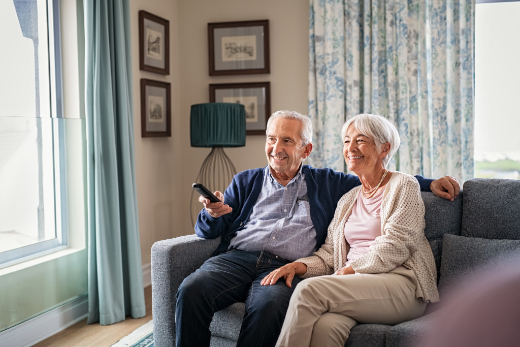 Senior couple watching TV at home