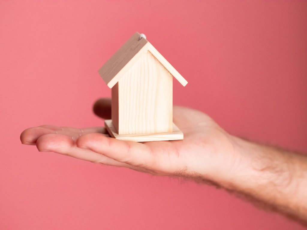 wooden house in the palm of hand