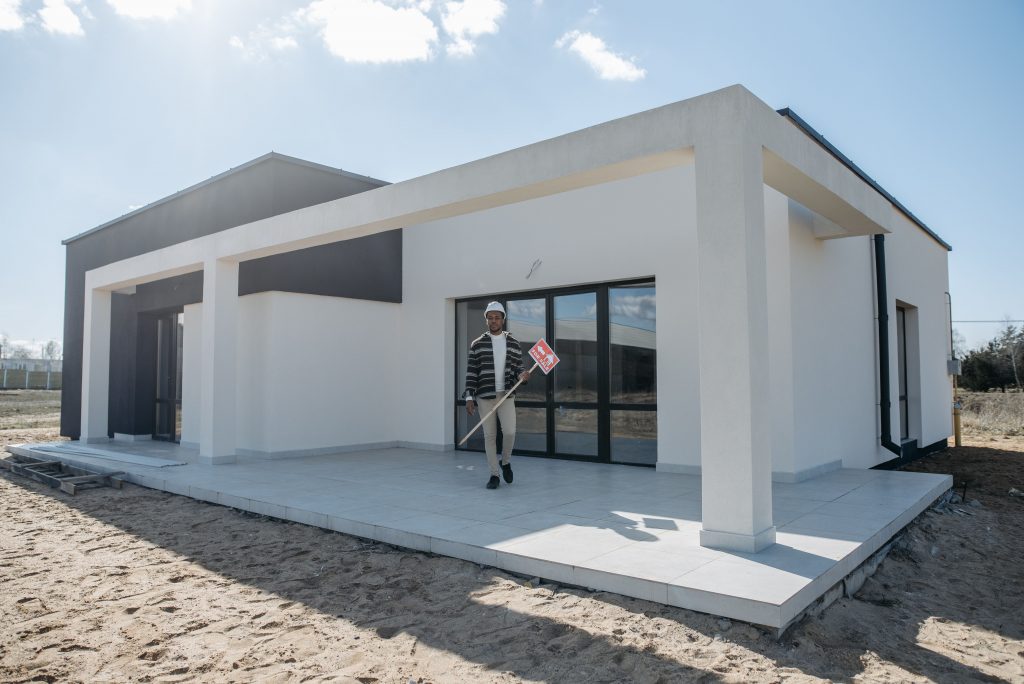 contractor standing in front of a new construction home