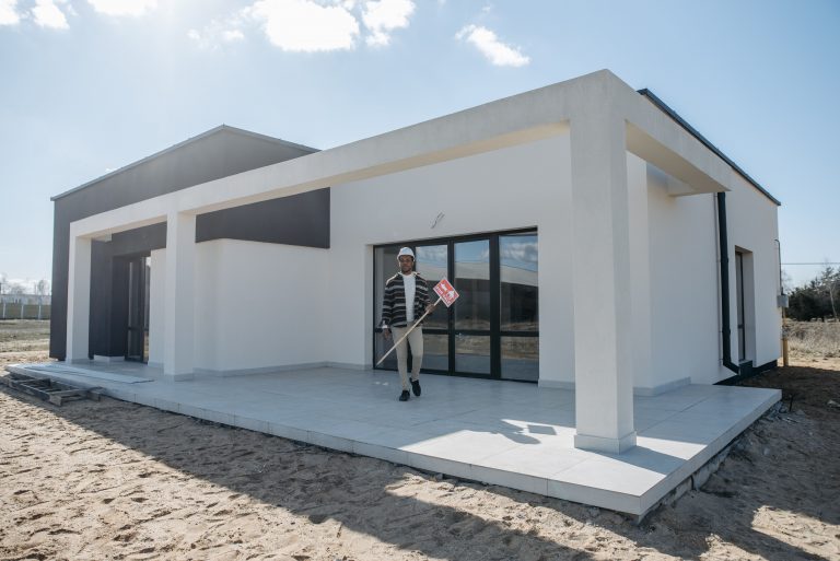 contractor standing in front of a new construction home