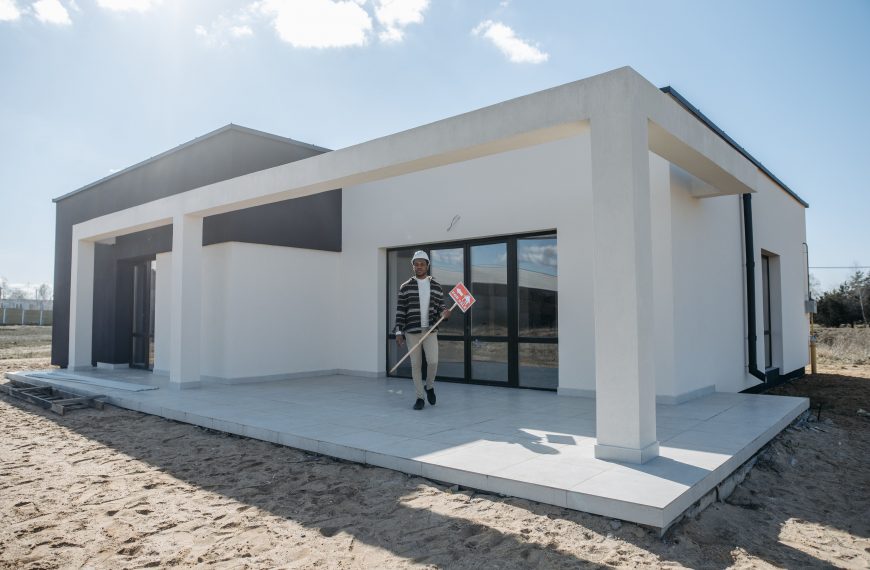 contractor standing in front of a new construction home